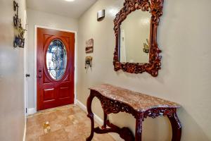 a red door and a table and a mirror at Wine Country Retreat in Paso Robles