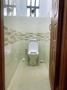 a bathroom with a toilet and a sink at Riri Country Living Isinya in Kitengela 