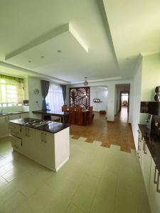 a large kitchen with an island in the middle of a room at Riri Country Living Isinya in Kitengela 