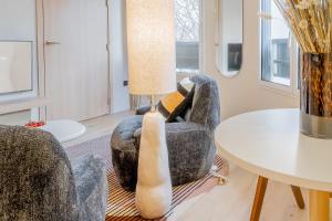 a living room with two chairs and a table at Yuna Porte-Maillot - ApartHotel in Paris