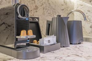 a bathroom with a soap dispenser on a counter at Yuna Porte-Maillot - ApartHotel in Paris