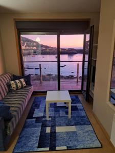 a living room with a couch and a table at Malecón Guardes in A Guarda