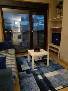 a living room with a couch and a table at Malecón Guardes in A Guarda