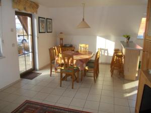 a kitchen and dining room with a table and chairs at Finnhäuser am Vogelpark - Haus Luise in Marlow