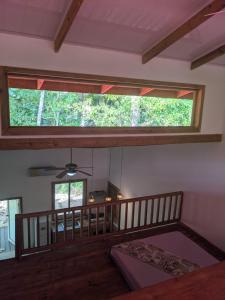 a room with a large window and a bed in it at Playa Bluff Lodge in Bocas del Toro