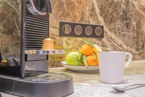 a counter with a cup of fruit and a microwave at Yuna Porte-Maillot - ApartHotel in Paris