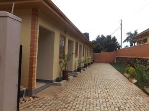 a building with a walkway with potted plants on it at Malaika Apartments Uganda in Kampala