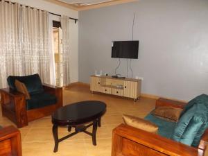 a living room with a couch and a table at Malaika Furnished Apartments in Kampala