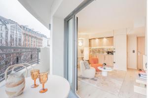 a living room with a view of a building at Yuna Porte-Maillot - ApartHotel in Paris