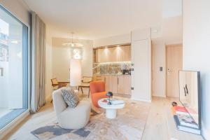 a living room with two chairs and a table at Yuna Porte-Maillot - ApartHotel in Paris