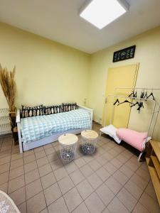 a room with a bed and two tables in it at Loft à partager in Seclin