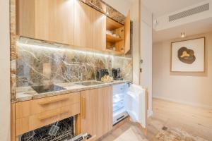 a kitchen with a sink and a stove at Yuna Porte-Maillot - ApartHotel in Paris