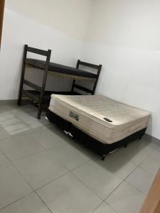 a bed and a chair in a room at Área de Lazer morada do sol in Sao Jose do Rio Preto