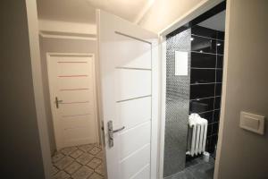 コシャリンにあるMieszkanie osiedle Północの白いドアとウォークインシャワー付きのバスルーム