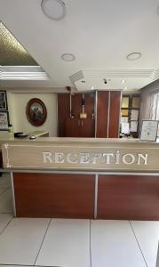 an office reception desk with a reputation sign on it at Royal Gur Hotel in Istanbul