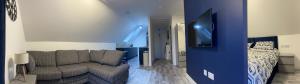 a living room with a couch and a bed at Lochside Loft - Self Catering Apartment for 2 In a great location for Inverness Airport and both Cabot Highlands & Nairn Golf Courses in Inverness