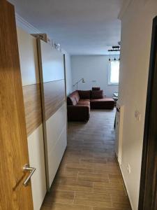 a hallway leading to a living room with a couch at Studio Leone Sunčana Planina in Kopaonik