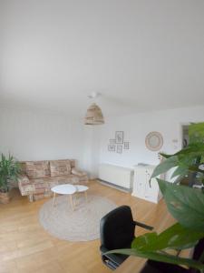 a living room with a couch and a table at HappyBNB Apartment mit sonniger Terrasse in Löchgau