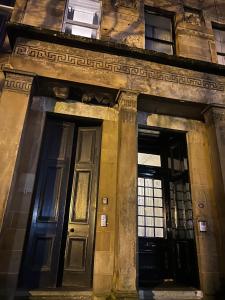 twee deuren aan de zijkant van een gebouw bij Alexander Greek Thomson Apartment in Glasgow