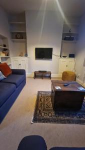 a living room with a couch and a coffee table at Stamford - 2 bed terrace house in Lincolnshire