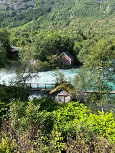 a small house in the middle of a river at Naustvoll in Olden