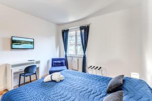 a bedroom with a blue bed and a blue chair at COSY FLAT CINECITTA' in Rome