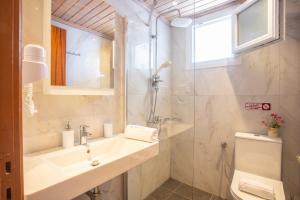 a bathroom with a sink and a shower at Romanza Studios in Vasiliki
