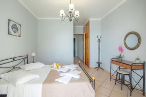 a bedroom with a bed and a desk and a table at Romanza Studios in Vasiliki