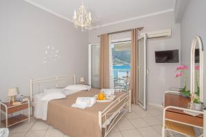 a bedroom with a bed and a view of the ocean at Romanza Studios in Vasiliki
