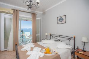 a bedroom with a bed with a view of the ocean at Romanza Studios in Vasiliki