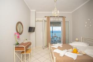 a bedroom with a bed and a table with a desk at Romanza Studios in Vasiliki