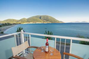 a bottle of wine sitting on a table on a balcony at Romanza Studios in Vasiliki