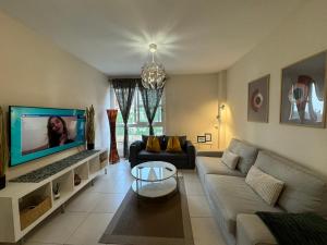 a living room with a couch and a tv at DREAM LAGUNA in Las Lagunas