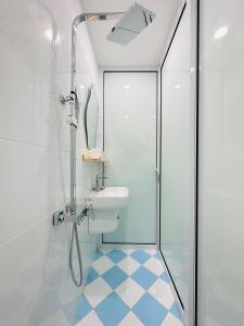 a bathroom with a shower and a toilet and a sink at RARE 200m2 4BR Private house @ Hoan Kiem 13pax in Hanoi