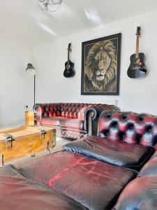 a living room with a couch and a tiger picture at Ground floor entire costal apartment in Watchet. in Watchet