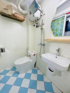 a bathroom with a toilet and a sink at RARE 200m2 4BR Private house @ Hoan Kiem 13pax in Hanoi