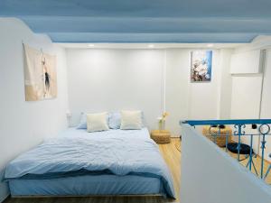 a bedroom with a bed with a blue ceiling at RARE 200m2 4BR Private house @ Hoan Kiem 13pax in Hanoi