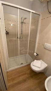 a white bathroom with a shower and a toilet at Il Girasole in Peschiera del Garda