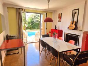 a dining room with a table and a fireplace at Stunning Home with Outdoor Swimmingpool, 4 Bedrooms and Wifi in Benalmádena