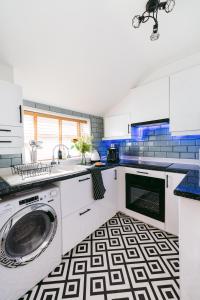 a kitchen with a washer and dryer on a floor at Central Retreat in Cardiff