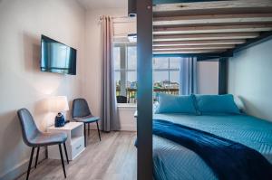 a bedroom with a blue bed and a window at Galveston Beach House w Water Views & New Pool in Galveston