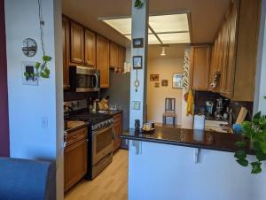 a kitchen with wooden cabinets and a stove top oven at Spacious 2 bedrooms. Prime Location (entire place) in Los Angeles