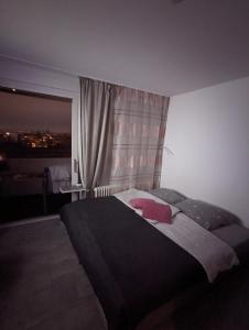 Un dormitorio con una cama grande y una ventana en Apartment Kornwestheim, en Kornwestheim