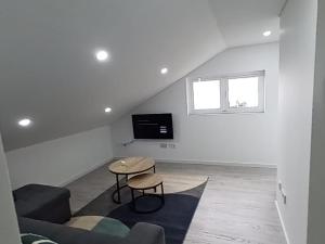 a living room with a couch and a table at Sunrise Bay - Modern Flat with stunning views in Seixal