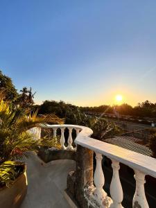 a balcony with a sunset in the background at SGH Castillo Aqua in Santa Marta