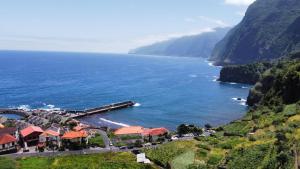 an aerial view of a resort on a cliff next to the ocean at Sunrise Bay - Modern Flat with stunning views in Seixal