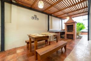 a dining room with a table and a fireplace at Markinkia - Estancia Amazónica in Macas