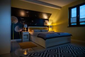 a bedroom with a king sized bed in a room at GOLD apartamenty & spa in Szczawnica