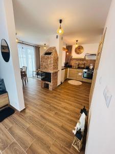 a kitchen and living room with a brick fireplace at FAMILY HAUSE in Witów