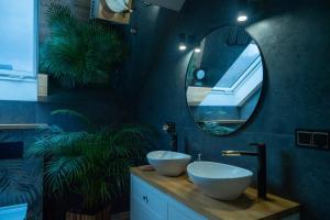 a bathroom with two white sinks and a mirror at GOLD apartamenty & spa in Szczawnica +212 photos
